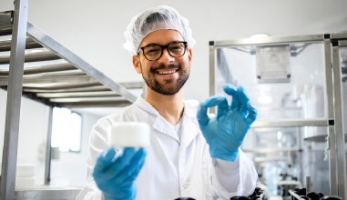 worker-holding-up-medicine-packaging